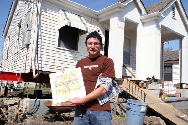 New Orleans, La., 3/8/06- Eric Martin stands in front of his home in Gentilly holding a sketch of what his house will look like after elevation and repairs are completed