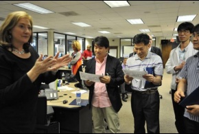 Mary Hudak of FEMA Region IV presents a photo to a group of emergency managers from Korea. The group attended briefings and toured the Regional Response Coordination Center.