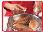 Checking cooked food temperature with food thermometer