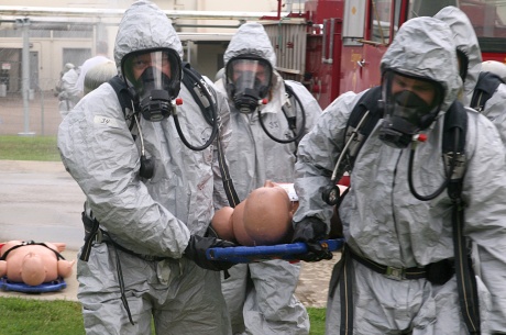 Center for Domestic Preparedness (CDP) Superintendent Todd Jones (pictured front-left), along with other members of his team, carry a simulated victim through the decontamination process during an exercise at the CDP. The CDP, in Anniston, Ala. instructs responders to determine their response tactics, select required equipment, personal protective levels, and decontamination procedures. Responding to All-Hazards, Mass-casualty events is a highlight and core principle behind CDP training. 