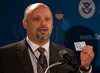 Howard Josephs, U.S. Department of State, holds up the new border crossing identification card at the RFID press event held at the San Ysidro port of entry.