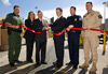 CBP Former Commissioner W. Ralph Basham along with representatives from the CBP operational offices and the San Diego Chamber of Commerce cut a ribbon signifying the completion of technology upgrades at the Port of San Ysidro.