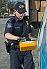 A Customs and Border Protection officer checks a vehicle entering the Super Bowl venue with a hand-held radiation detection unit.