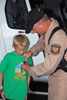 Air and Marine agent pins a badge on a young attendee.