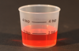 Medicine Cup with tsp Markings and Red Liquid