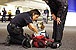A CBP Agriculture Specialist checks to see what her partner, Tyco, has detected in a traveler’s carry-on bag at the San Francisco International Airport.