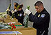 Four CBP agriculture specialists inspect shipments of incoming flowers. 