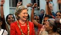 Secretary Clinton smiling at a woman standing near her in India (AP Images)
