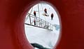 View through porthole of scientists and equipment on ice (NASA/Kathryn Hansen)