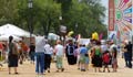 People walking toward festival tents (State Dept.)