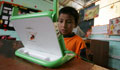 A boy reading on his XO laptop (AP Images) 