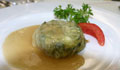 Snail timbale: diced snails, potatoes and leeks wrapped in savoy cabbage and served with a snail juice reduction (AP Images) 