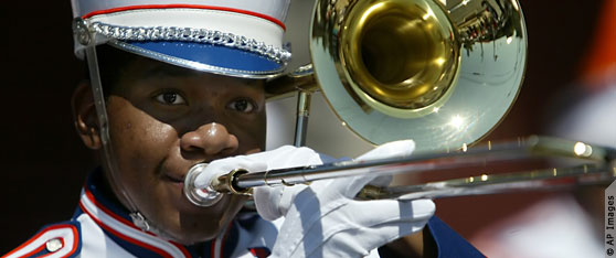 Close-up of student in marching band uniform playing trombone (AP Images)