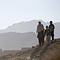 Boys standing on a hill near an Afghan town (AP Images)