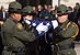Members of the Customs and Border Protection Honor Guard carefully inspect a folded ceremonial flag in Washington D.C. at a CBP memorial service.