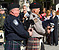 A CBP officer and an Air and Marine agent play bagpipes in Washington D.C at a memorial service honoring fallen officers and agents during National Police Week.