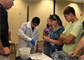 Students at the Army STEM Exposition create test samples using rapid set runway repair cement developed by ERDC.