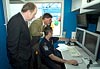 CBP Commissioner Robert C. Bonner and Governor  Robert L. Ehrlich Jr are shown how the new Mobile Sea Container system operates by a CBP officer.