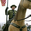 Deputy Chief of the Border Patrol R.L. Harris carries the U.S. Flag on horseback for the Inaugural Parade in Washington D.C.