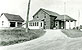 1940's photograph of the U.S. border inspection station at Morses Line, Vt. The border station was built in 1935 on the west side of Morses Line Road (State Route 235.) A small office for the Customs and Immigration inspectors stationed at the port is accessed from door opening off the canopied driveway. Residential quarters for the officers and their families consisted of living rooms and kitchens at the rear of the first floor, which were accessed by enclosed private entrances on both sides of the building; bedrooms and bathrooms were located on the second floor An identical size border inspection station was constructed in Alburgh Springs, Vt. in 1937, and it too is still in operation today.