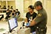 A CBP Border Patrol agent utilizes an automated fingerprint recognition system to process an idividual who entered the U.S. illegally. 