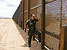 U.S. Border Patrol Agent Martin Hernandez stands at the 18-foot tall pedestrian fence at the Santa Teresa port of entry in New Mexico.