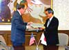 U.S. Customs Commissioner Robert C. Bonner and Japanese Customs and Tariff Bureau Director General Yoshio Tamura.