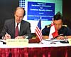 U.S. Customs Commissioner Robert C. Bonner signs the Container Security Initiative with Koh Chong Hwa, director-general of Singapore's Customs and Excise Department.