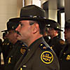 Acting Associate Chief Daniel B. Doty, U.S. Border Patrol Headquarters, along with Border Parol agents, listens to Commissioner Bonner as he gives his welcome speech.