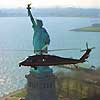 An ICE Blackhawk helicopter provides airspace security over the Statue of Liberty.