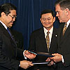 Homeland Security Secretary Tom Ridge and Surakiart Sathiratathai, Foreign Minister, Kingdom of Thailand, shake hands after a Container Security Initiative signing.