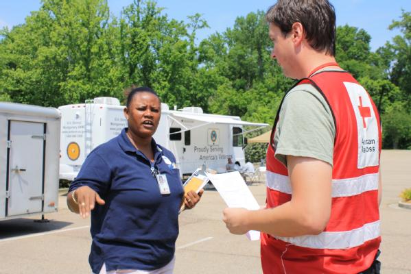 Shnader Bellegrade, FEMA Community Relations Specialist collaborates with Todd Hallbaur of the American Red Cross.