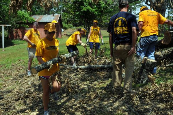 Members of the Florida Southern Baptist Disaster Relief Association are helping a homeowner cut and pull debris.