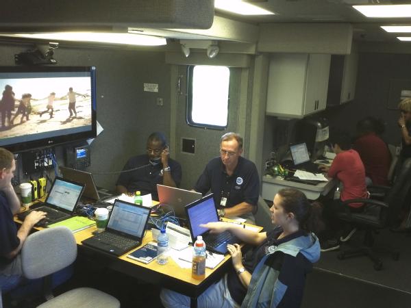 EMA personnel work inside a Mobile Emergency Response Support vehicle.