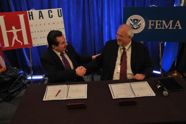 Dr. Antonio Flores, President and chief executive officer of the Hispanic Association of Colleges and Universities shake hands with FEMA Administrator W. Craig Fugate