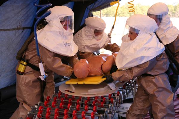 Healthcare workers rush to decontaminate a simulated victim during an exercise at the Center for Domestic Preparedness, located in Anniston, Ala.