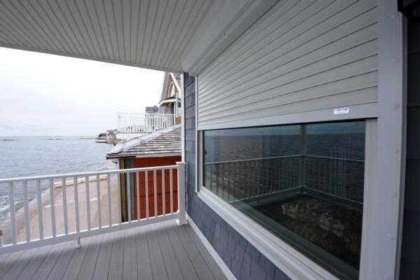 Above: Permanent rolling shutters helped reduce damages to this home along the Long Island Sound in East Haven, Conn. during Tropical Storm Irene.