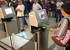 A pedestrian entering the U.S. at Paso Del Norte uses the new automated gate to scan her travel document and fingerprints before approaching the CBP officer. 