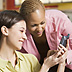 Photo of two women looking at a smartphone.