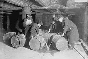 Agents from the Prohibition Patrol pour booze down the hatch.