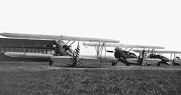 Two Curtiss Falcons and a Waco, showing improvised U.S. Customs seals & flag, outside hangar at Dodd Field, Fort Sam Houston, San Antonio, Texas. 