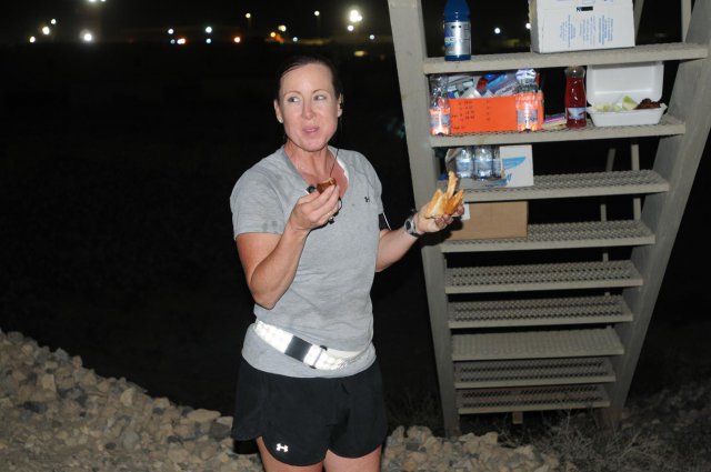 During her 100-mile run, Sgt. 1st Class Rita "Missy" Rice carried her own water. There was no traffic stopped for her. No T-shirts or medals were handed out and there was no fanfare along the run. Rice, 12 hours into her run, gets a quick drink and a bite to eat.