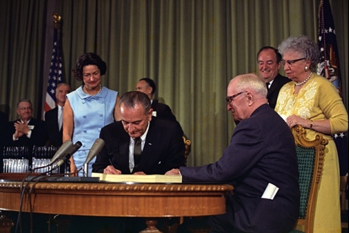 President Lyndon Johnson signs the Medicare Bill at the Harry S. Truman Library in Independence, Missouri