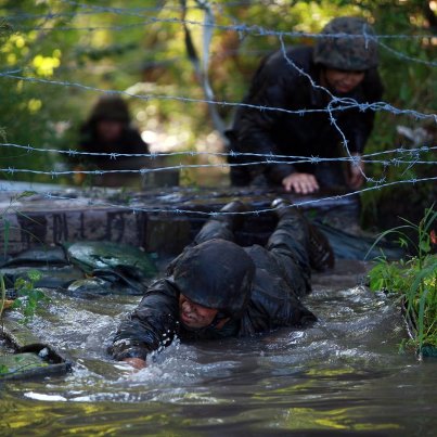 Photo: Marines crawl under barbed wire to get to the finish line during the endurance course at Battle Skills Training School aboard Camp Lejeune, N.C. 

Photo by Sgt Rachael Moore