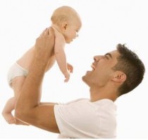 Father is holding up his infant son.