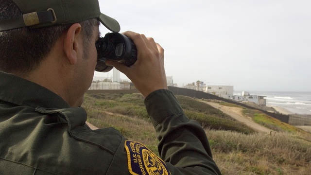 Border patrolman with binoculars