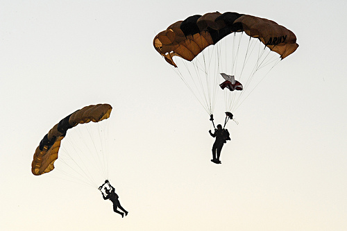 <p>U.S. Soldiers with the Golden Knights glide into the Pentagon parking lot during the 28th Annual Army-Ten Miler in Washington, Oct. 21, 2012. The Army Ten-Miler was produced by the U.S. Army Military District of Washington and all proceeds go to the Army?s Morale, Welfare and Recreation fund. (DoD photo by Staff Sgt. Teddy Wade, U.S. Army/Released)</p>