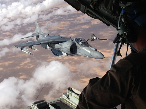 <p>A U.S. Marine watches from a KC-130J Hercules aircraft as an AV-8B Harrier aircraft assigned to Marine Aviation Weapons and Tactics Squadron 1 is refueled over Yuma, Ariz., Oct. 11, 2012. (DoD photo by Capt. Staci Reidinger, U.S. Marine Corps/Released)</p>