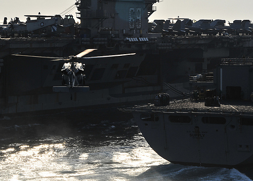 <p>A U.S. Navy MH-60S Knighthawk helicopter prepares to pick up cargo from the fast combat support ship USNS Supply (T-AOE 6) during a replenishment at sea with the aircraft carrier USS Dwight D. Eisenhower (CVN 69) in the Arabian Sea Oct. 18, 2012. Dwight D. Eisenhower was deployed to the U.S. 5th Fleet area of responsibility conducting maritime security operations, theater security cooperation efforts and support missions as part of Operation Enduring Freedom. (DoD photo by Mass Communication Specialist 3rd Class Jonathan Sunderman, U.S. Navy/Released)</p>