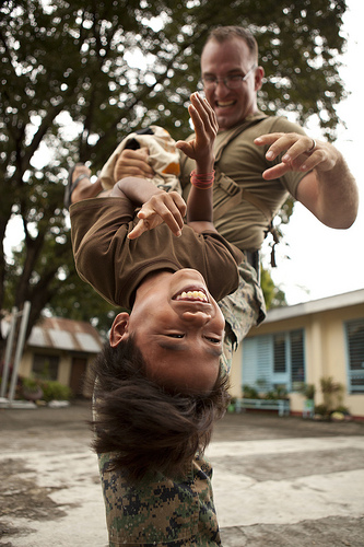 <p>U.S. Marine Corps Staff Sgt. Timothy Davis, assigned to Marine Wing Support Squadron (MWSS) 172, plays with a Filipino student during an engineering civil assistance project at the Dallipawen Elementary School in San Narciso, Philippines, Oct. 4, 2012, in support of Amphibious Landing Exercise (PHIBLEX) 2013. PHIBLEX is a bilateral training exercise designed to improve the interoperability, readiness and professional relationships between the U.S. Marine Corps and partner nations. (DoD photo by Sgt. Matthew Troyer, U.S. Marine Corps/Released)</p>